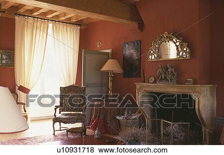 Red livingroom with white curtains and ornate mirror over fireplace View Large Photo Image Stock Photo - Red livingroom with white curtains and ornate mirror over fireplace. Fotosearch