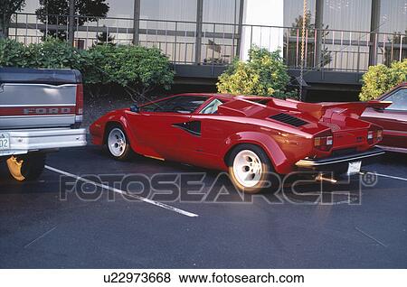 Red sportscar on parking lot View Large Photo Image Stock Photo - Red sportscar on parking lot. Fotosearch