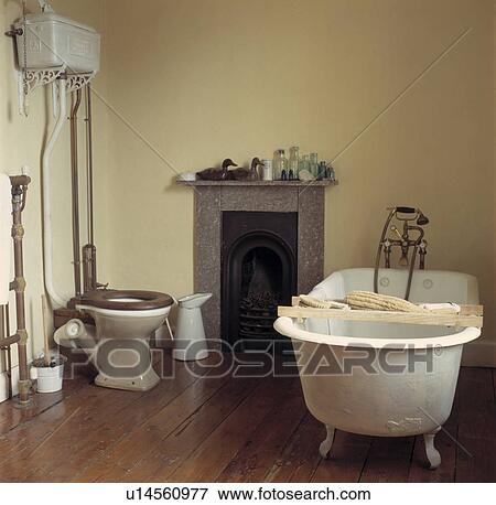 Rolltop Bath With Wooden Rack In Bathroom With Wooden Flooring And