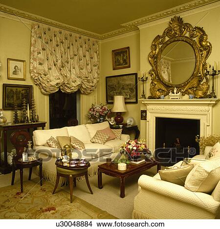 Picture - Ruched blind on window in traditional town living room. Fotosearch