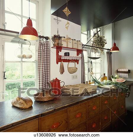 Rustic wooden drawers below windows in Scandinavian country kitchen View Large Photo Image Stock Photograph - Rustic wooden drawers below windows in Scandinavian country kitchen. Fotosearch