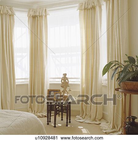 Sculpture And Photographs On Moroccan Brass Wood Table In Front