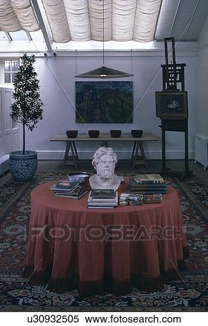 Stock Photography - Sculpture head on table with red cloth. Fotosearch