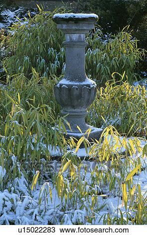 Stock Image - Sculpture in country garden in winter. Fotosearch