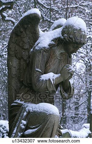 Stock Photo - Sculpture in snow in country garden in winter. Fotosearch
