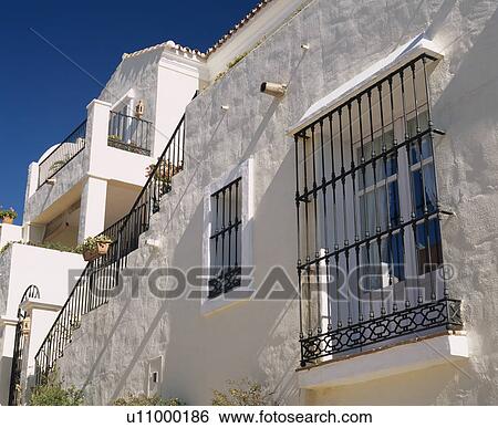 Stock Photograph - Security bars on window of white villa in Southern Spain. Fotosearch