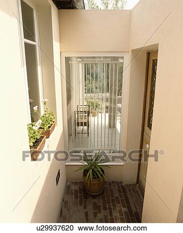 Security grill in wall beside garden door View Large Photo Image Stock Image - Security grill in wall beside garden door. Fotosearch