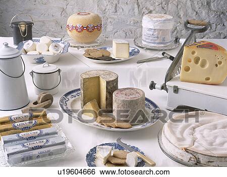 Selection of cheeses on table with cheese slicer View Large Photo Image Stock Photograph - Selection of cheeses on table with cheese slicer. Fotosearch