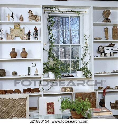 Shelves framing window in modern white country living room View Large Photo Image Picture - Shelves framing window in modern white country living room. Fotosearch