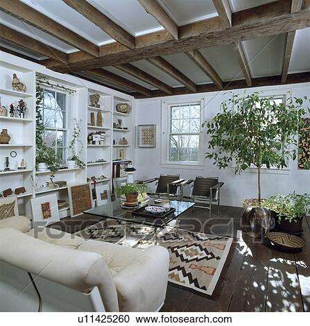 Shelves framing window in modern white country living room View Large Photo Image Stock Image - Shelves framing window in modern white country living room. Fotosearch