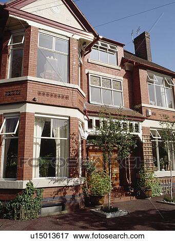 Small tree in pot in front garden of red brick Edwardian townhouse View Large Photo Image Stock Photo - Small tree in pot in front garden of red brick Edwardian townhouse. Fotosearch