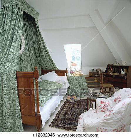 Spare Bedroom In Attic Room With Green Printed Drapes Over The Bed