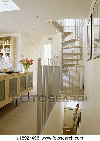 Spiral staircase from modern living room and white landing View Large Photo Image Stock Photograph - Spiral staircase from modern living room and white landing. Fotosearch