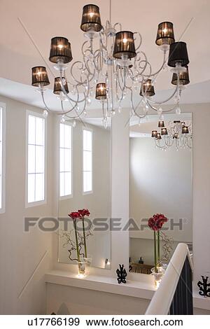 Stainless steel chandelier with lampshades above modern white landing View Large Photo Image Stock Photo - Stainless steel chandelier with lampshades above modern white landing. Fotosearch