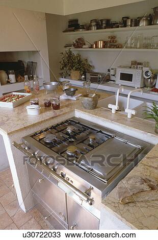 Stainless steel range oven in island unit in modern white country kitchen View Large Photo Image Stock Image - Stainless steel range oven in island unit in modern white country kitchen. Fotosearch
