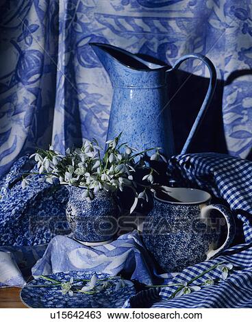 Stock Image - Still-Life of blue jugs and snowdrops. Fotosearch