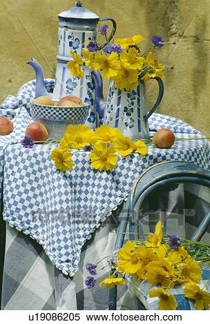 Stock Photography - Still-Life of blue+white coffeepots and yellow daisies. Fotosearch