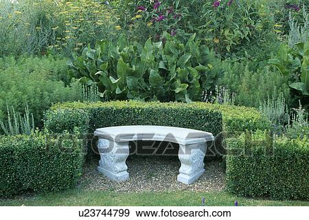 Stone bench and low clipped hedges in large country garden View Large Photo Image Stock Photo - Stone bench and low clipped hedges in large country garden. Fotosearch