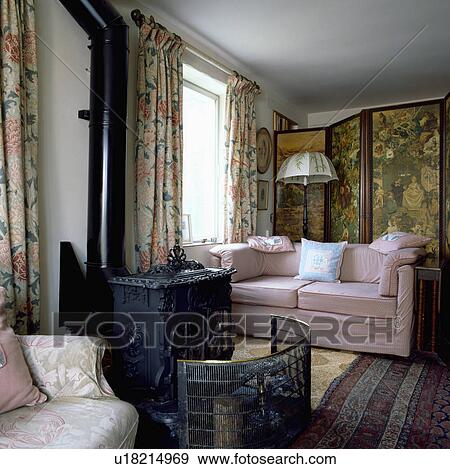 Stove in traditional living room with pink sofa View Large Photo Image Stock Photo - Stove in traditional living room with pink sofa. Fotosearch