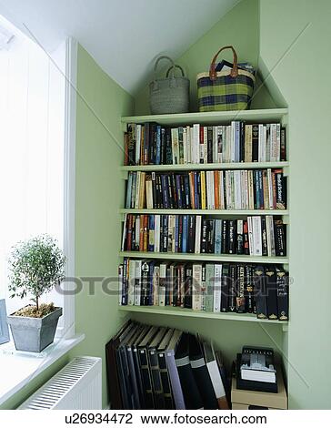 Straw baskets on alcove bookshelves in pastel green home office View Large Photo Image Stock Image - Straw baskets on alcove bookshelves in pastel green home office. Fotosearch