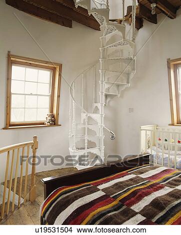 Striped woollen blanket on bed in circular bedroom with white spiral staircase in converted lighthouse View Large Photo Image Picture - Striped woollen blanket on bed in circular bedroom with white spiral staircase in converted lighthouse. Fotosearch