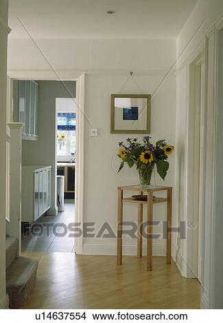 Sunflowers on wooden table in the corner of white hall with wooden flooring View Large Photo Image Picture - Sunflowers on wooden table in the corner of white hall with wooden flooring. Fotosearch