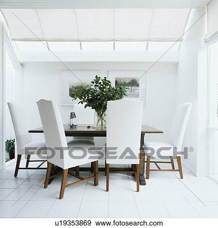 Tall Backed Upholstered White Chairs And Old Table In Modern White