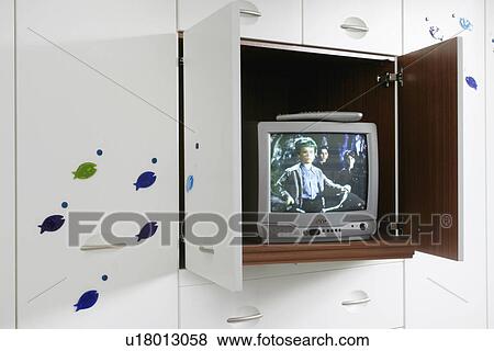 Television stored in white fitted cupboard View Large Photo Image Stock Photo - Television stored in white fitted cupboard. Fotosearch