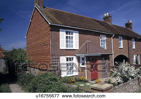 Stock Photo - Terraced cottage with spirea in flower in the front garden . Fotosearch