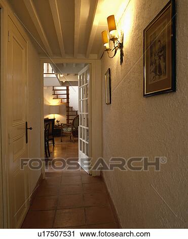 Terracotta tiled floor and roughly plastered walls below white beamed ceiling and wall-light in narrow hall View Large Photo Image Stock Image - Terracotta tiled floor and roughly plastered walls below white beamed ceiling and wall-light in narrow hall. Fotosearch