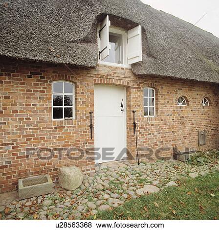 Thatched brick German cottage conversion. View Large Photo Image Stock Photo - Thatched brick German cottage conversion.. Fotosearch
