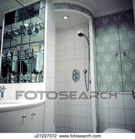Tiled corner shower unit in a small green and white bathroom View Large Photo Image Stock Image - Tiled corner shower unit in a small green and white bathroom. Fotosearch