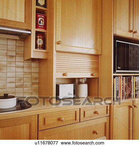 Toaster and mixer concealed in kitchen cupboard with fold-up door View Large Photo Image Stock Photo - Toaster and mixer concealed in kitchen cupboard with fold-up door . Fotosearch