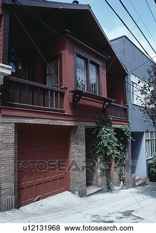 Traditional American townhouse with balcony above garage door View Large Photo Image Stock Photo - Traditional American townhouse with balcony above garage door. Fotosearch