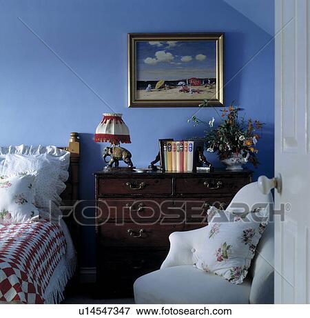 Traditional Blue Bedroom With Dark Wood Antique Chest Of