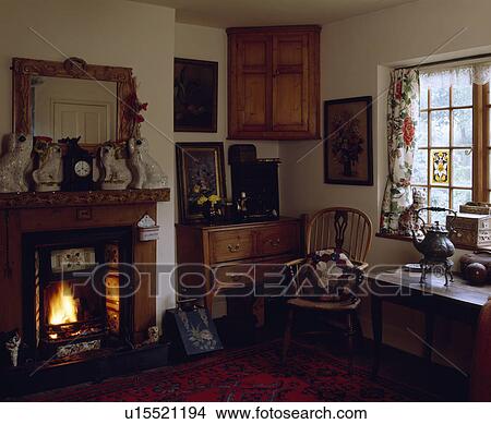 Traditional country living room with lighted fire in fireplace View Large Photo Image Picture - Traditional country living room with lighted fire in fireplace. Fotosearch