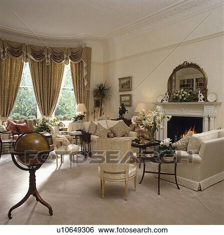 Traditional cream town living room with swagged curtains View Large Photo Image Stock Photograph - Traditional cream town living room with swagged curtains. Fotosearch