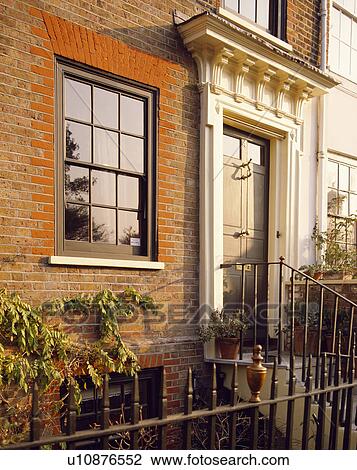 Traditional Georgian House With Pediment Over The Front Door And Wrought Iron Railings Stock Image