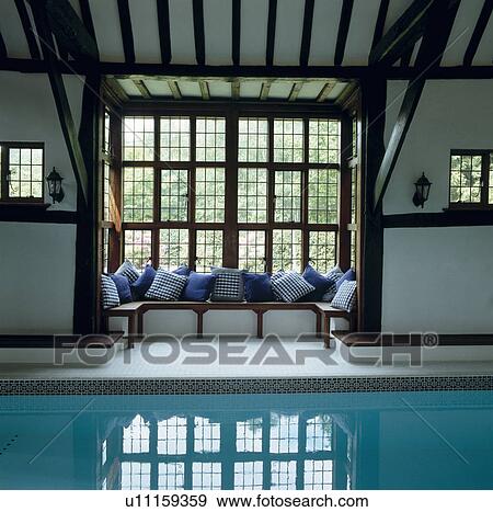 Stock Photo - Traditional indoor swimming pool with cushions on windowseat. Fotosearch
