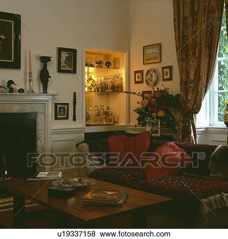 Stock Photo - Traditional living room with shelving in lighted alcove. Fotosearch