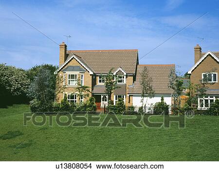 Traditional newbuild house on the edge of a field View Large Photo Image Picture - Traditional newbuild house on the edge of a field. Fotosearch