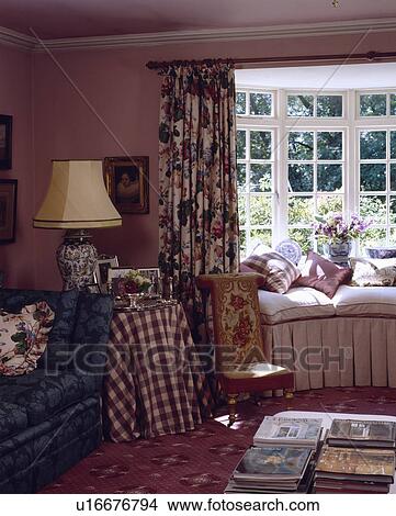 Picture - Traditional pink country cottage with window seat. Fotosearch