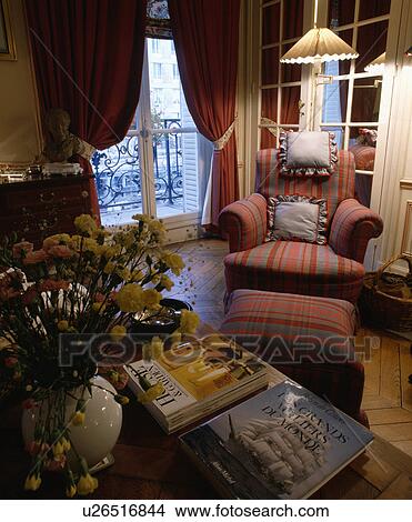 Picture - Traditional town living room with red armchair and curtains. Fotosearch