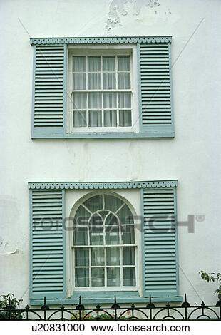 Turquoise louvre shutters on arched and sash windows of Victorian townhouse View Large Photo Image Stock Image - Turquoise louvre shutters on arched and sash windows of Victorian townhouse. Fotosearch