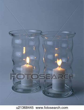 Two lighted candles in glass containers View Large Photo Image Stock Photography - Two lighted candles in glass containers. Fotosearch