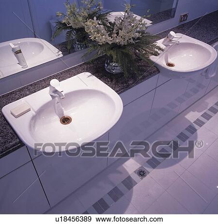 Two white basins set into marble top with storage underneath View Large Photo Image Stock Photo - Two white basins set into marble top with storage underneath. Fotosearch