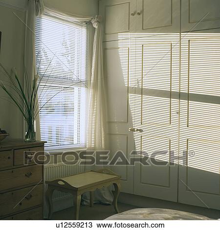 Venetian blind in bedroom with fitted cupboards View Large Photo Image Stock Image - Venetian blind in bedroom with fitted cupboards. Fotosearch