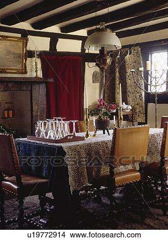 Victorian glass and brass lantern over table in beamed country dining room with leather chairs View Large Photo Image Picture - Victorian glass and brass lantern over table in beamed country dining room with leather chairs. Fotosearch