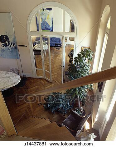 View From Staircase To Dining Room With Large Houseplants And