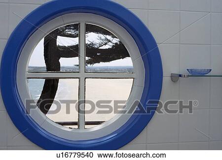 View of seaside beach through circular blue & white window View Large Photo Image Stock Image - View of seaside beach through circular blue & white window. Fotosearch